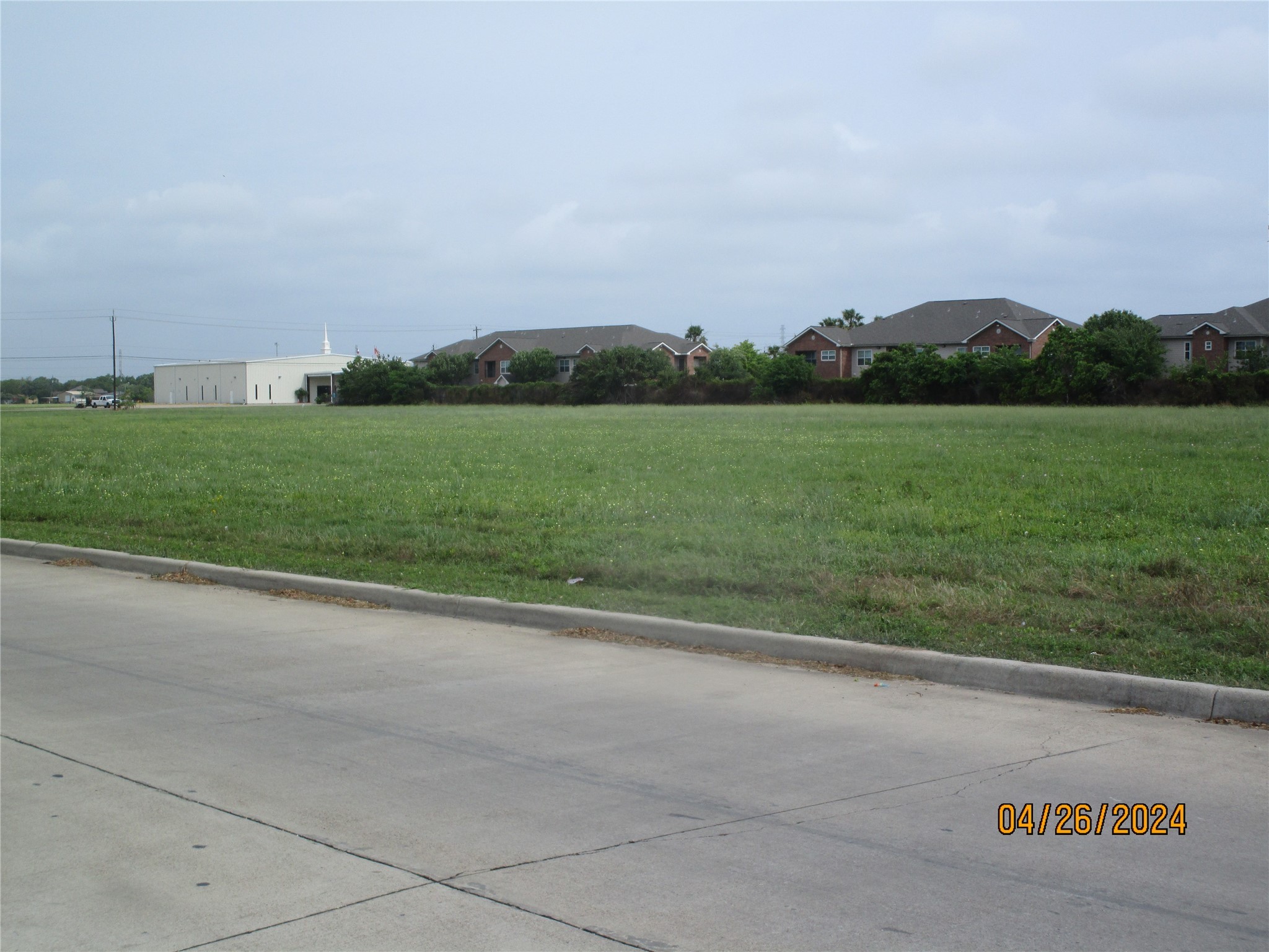 0 Skinner Street Freeport, TX 77541 - Photo 5 of 13 a view of a field with grass and trees