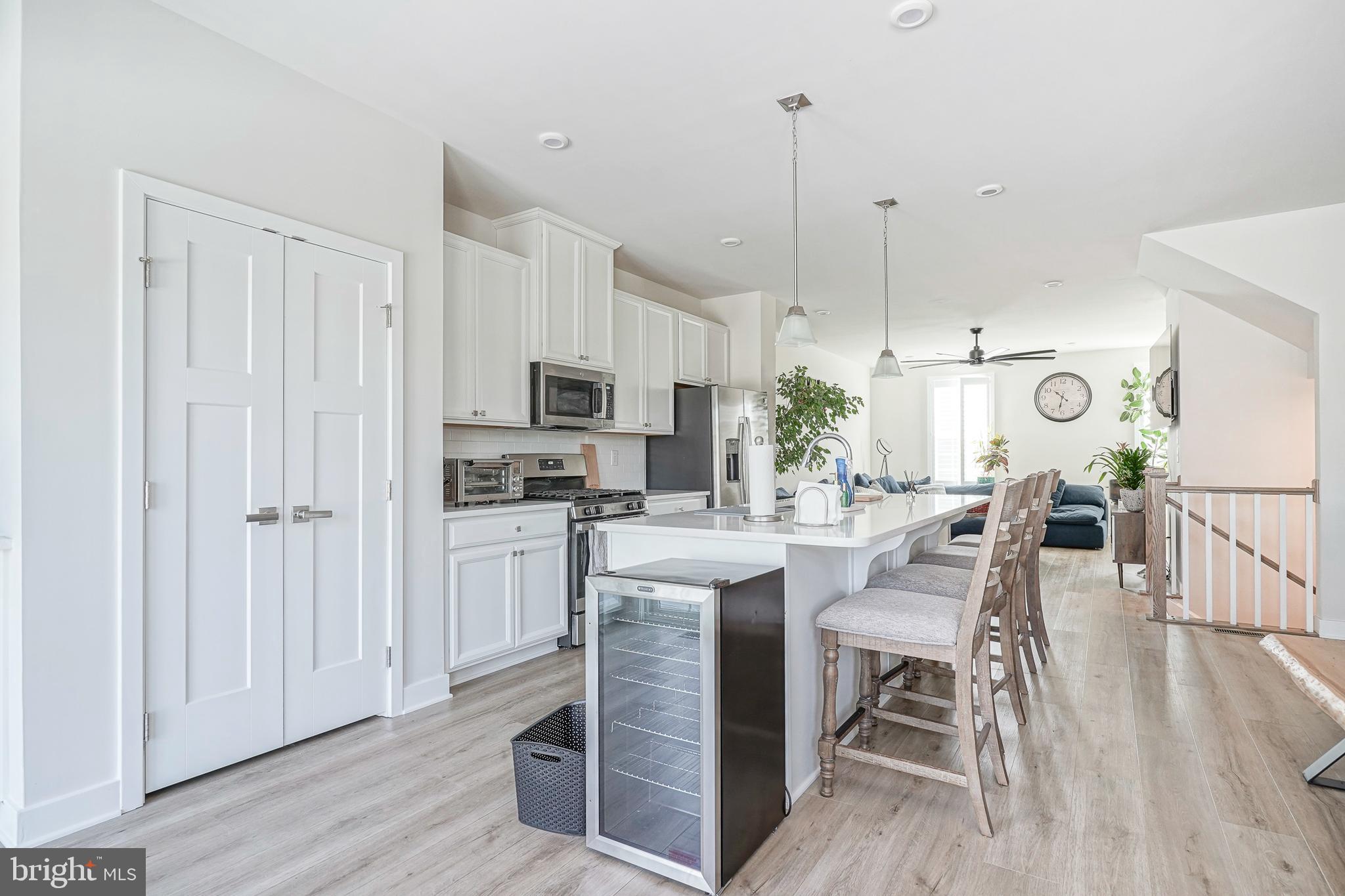 188 Freedom Way Sicklerville, NJ 08081 - Photo 11 of 32 a kitchen with stainless steel appliances kitchen island granite countertop a table chairs and a refrigerator