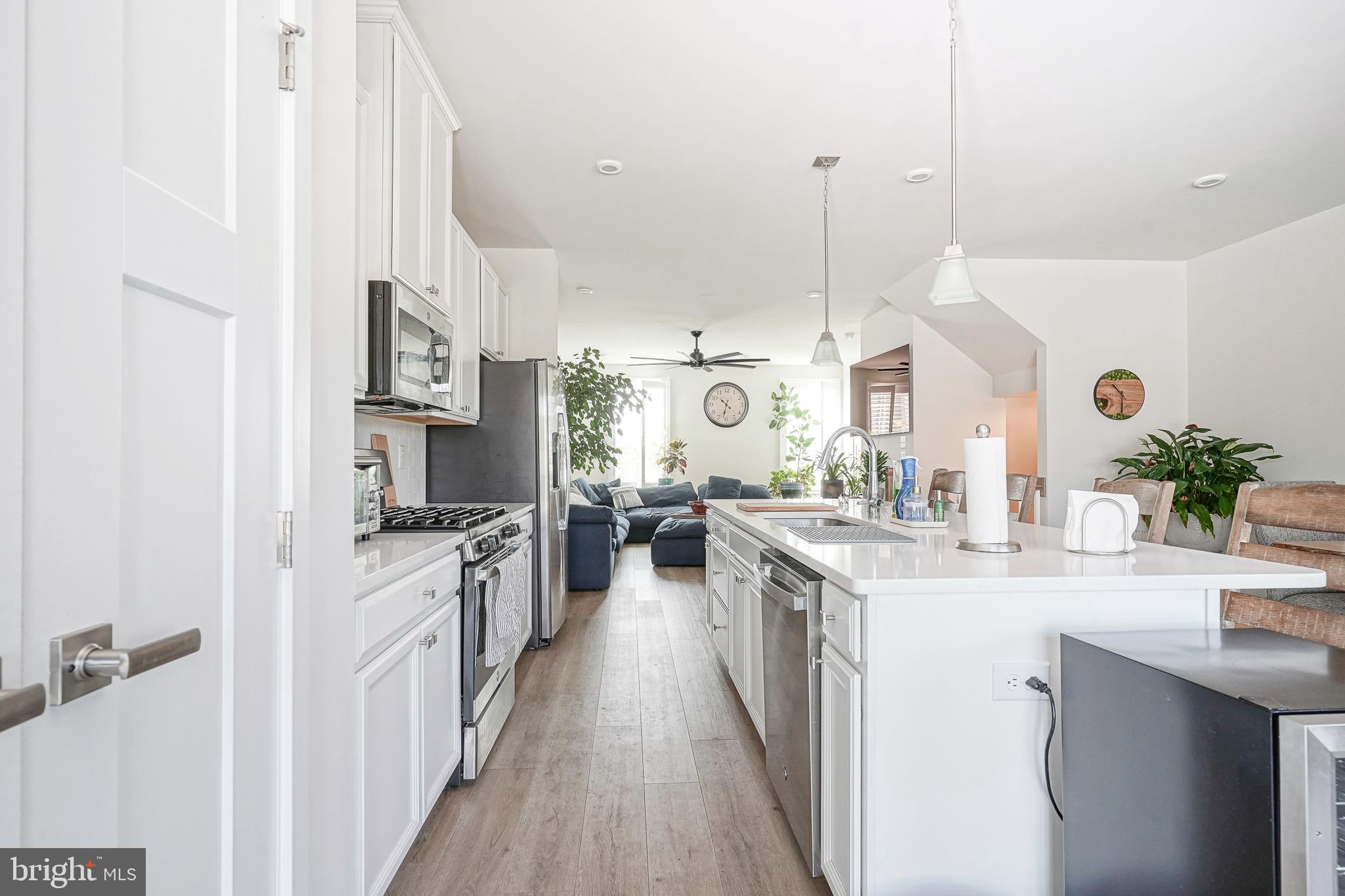 188 Freedom Way Sicklerville, NJ 08081 - Photo 13 of 32 a kitchen with stainless steel appliances kitchen island granite countertop a sink a stove top oven a counter space and cabinets