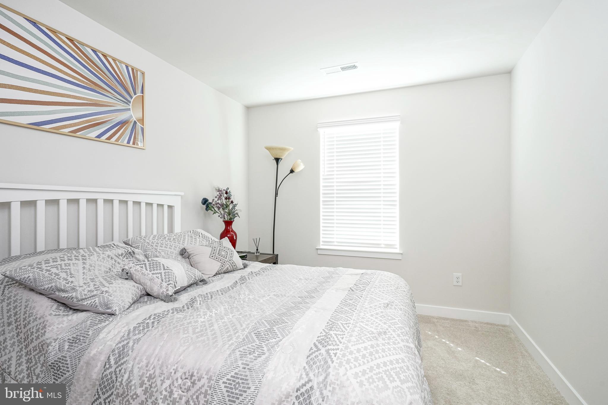 188 Freedom Way Sicklerville, NJ 08081 - Photo 23 of 32 a bed sitting in a bedroom next to a window