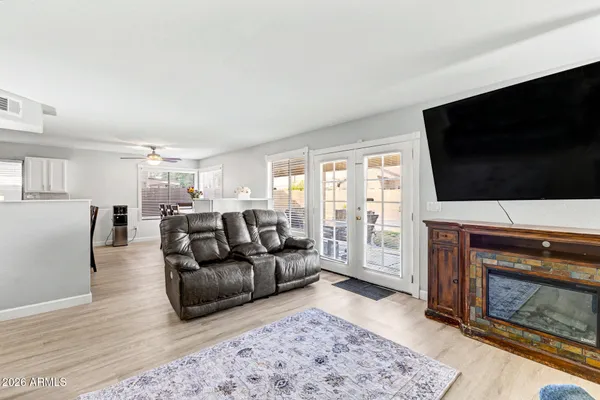 a living room with furniture a flat screen tv and a fireplace