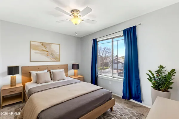 a bedroom with a bed and a painting on the wall