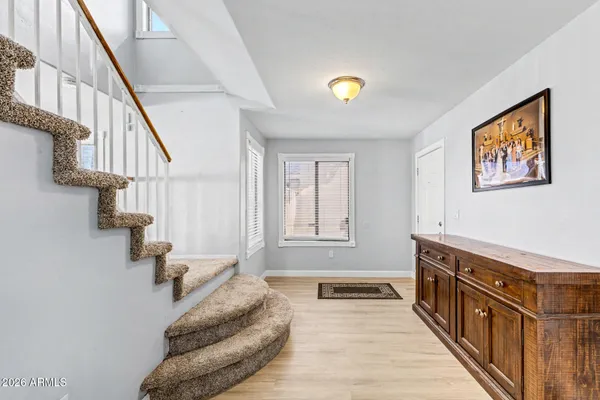 a view of entryway and hall with wooden floor