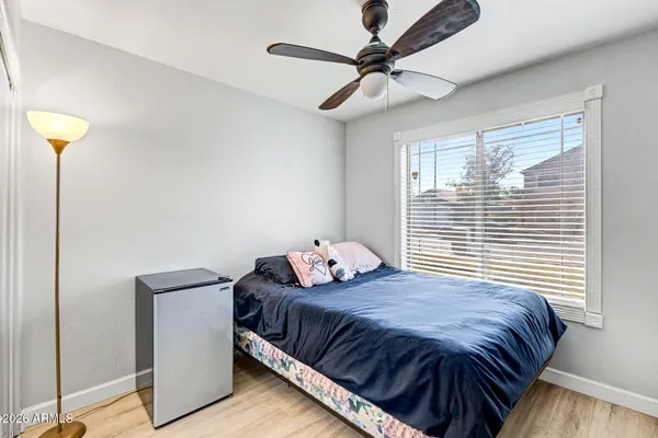 a bedroom with a large bed and a chandelier
