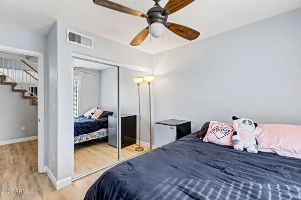a bedroom with a bed and wooden floor