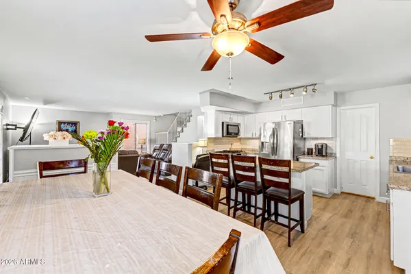 a dining room with furniture and wooden floor