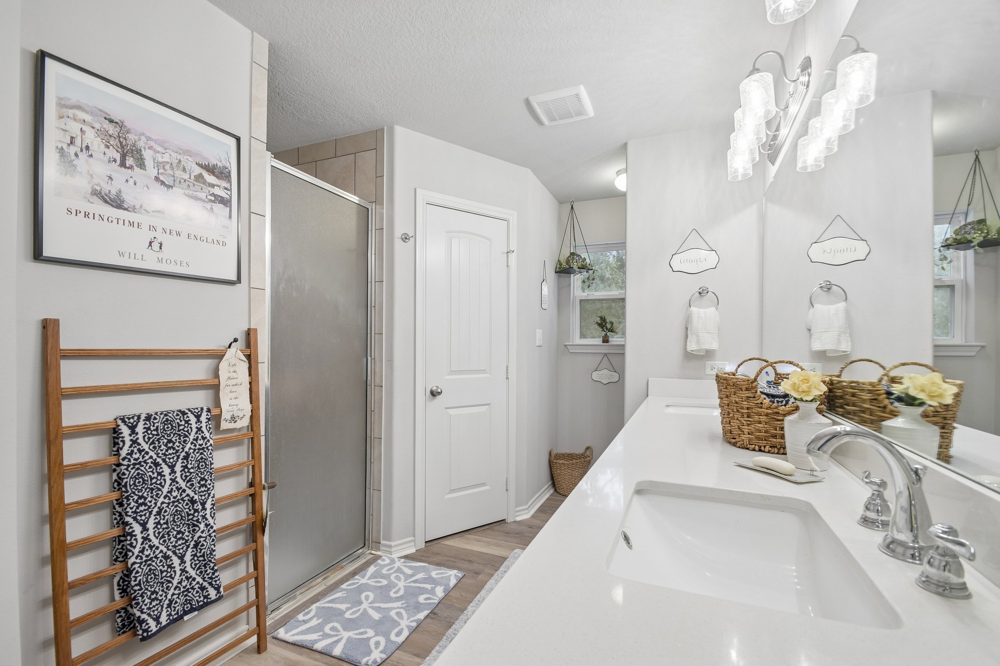 596 Pleasant Grove Loop Elgin, TX 78621 - Photo 23 of 37 A spacious bathroom features a sleek double vanity, stone countertops, and a walk-in shower.