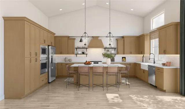 a large kitchen with kitchen island a sink stainless steel appliances and cabinets
