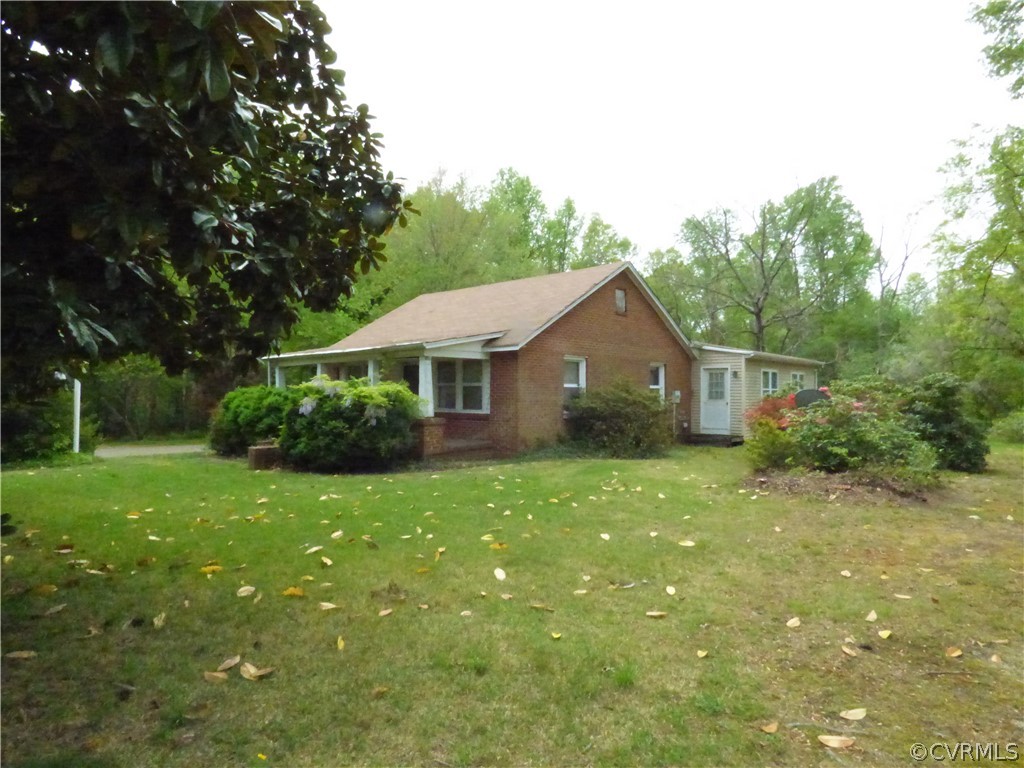 a front view of house with a garden