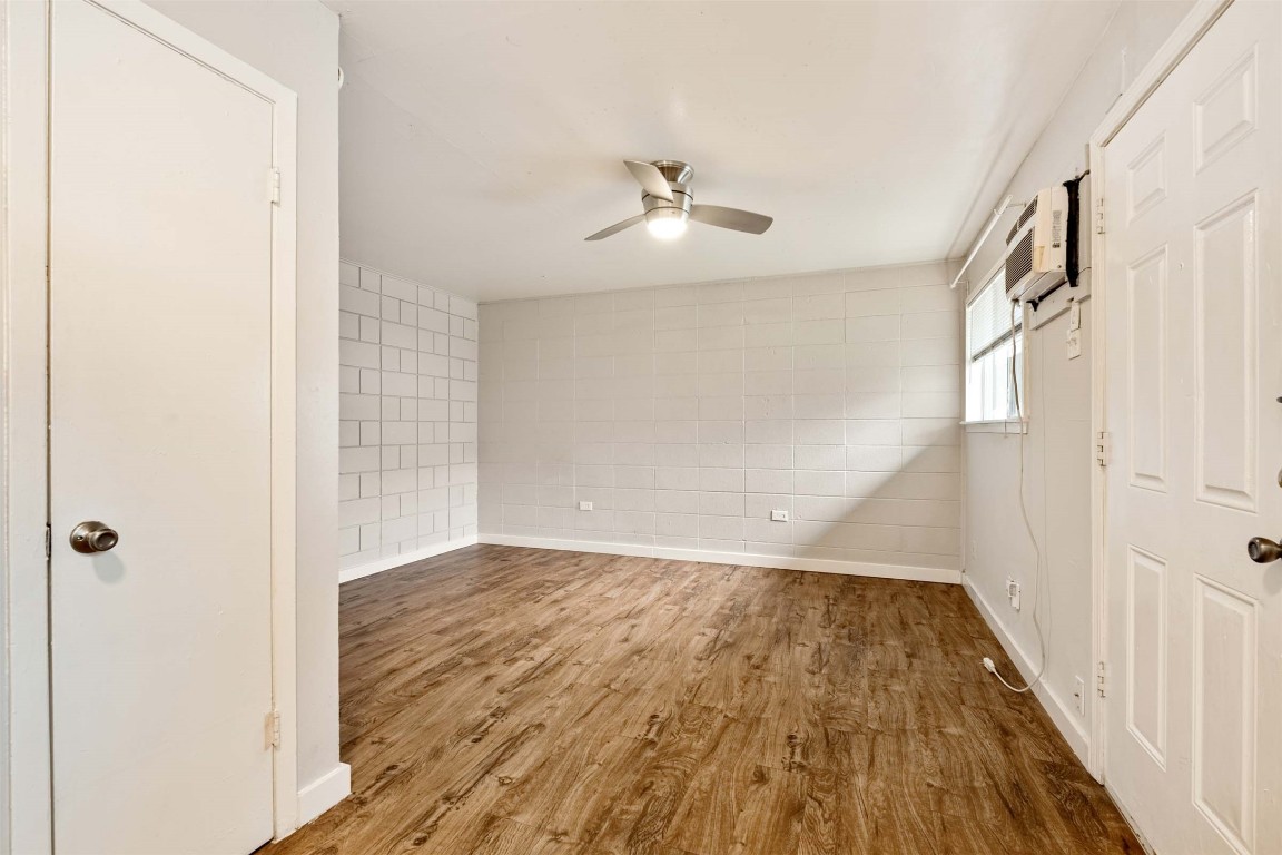 903 Springdale Road, Unit E Austin, TX 78702 - Photo 11 of 16 Spare room featuring wood finished floors and a ceiling fan