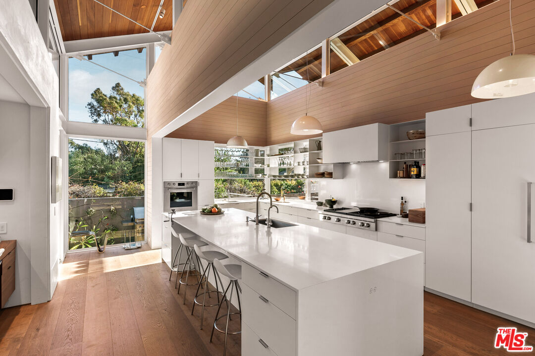 6728 Wildlife Road Malibu, CA 90265 - Photo 12 of 57 a kitchen with stainless steel appliances a sink a stove and a refrigerator