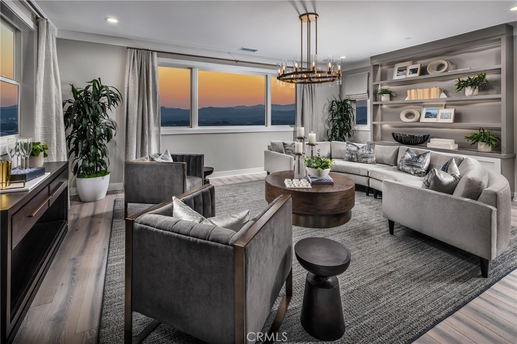 20320 Marlow Lane Porter Ranch, CA 91326 - Photo 12 of 16 a living room with furniture a chandelier and a floor to ceiling window