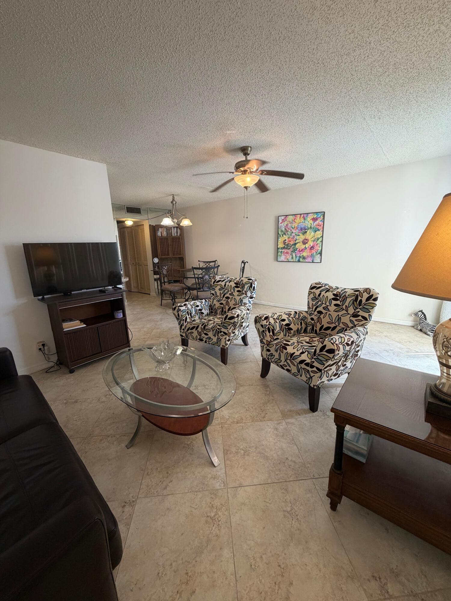 3058 Ainslie Drive, Unit 3058D Boca Raton, FL 33434 - Photo 11 of 13 a living room with furniture and a chair