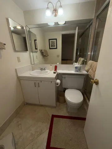 a bathroom with a toilet sink and mirror
