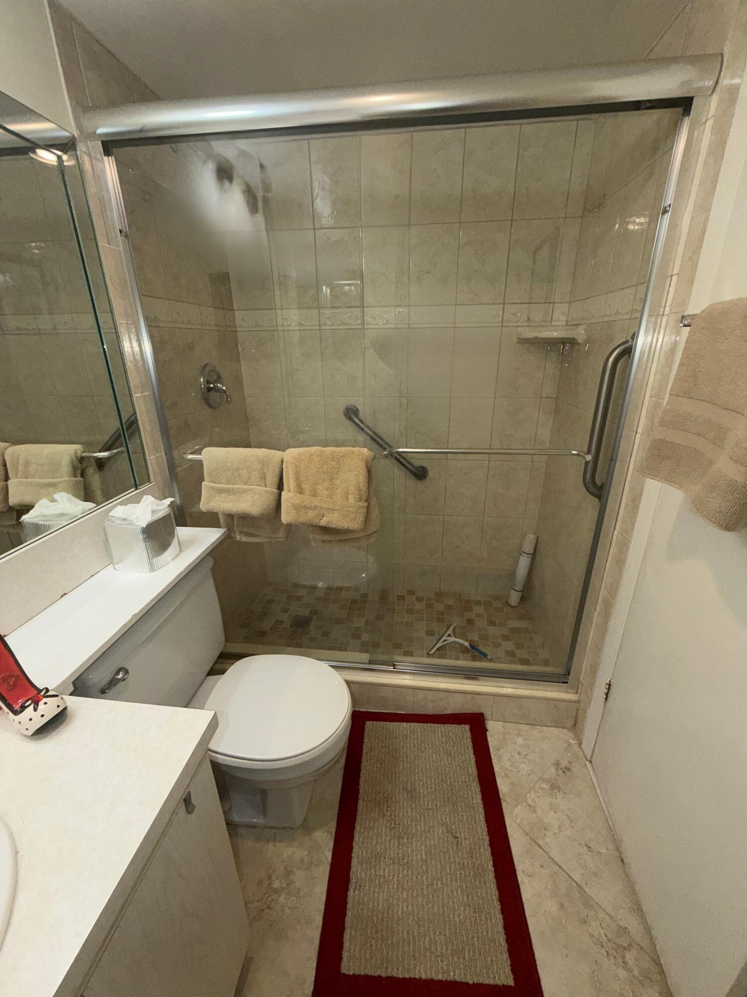 3058 Ainslie Drive, Unit 3058D Boca Raton, FL 33434 - Photo 5 of 13 a bathroom with a sink and a mirror