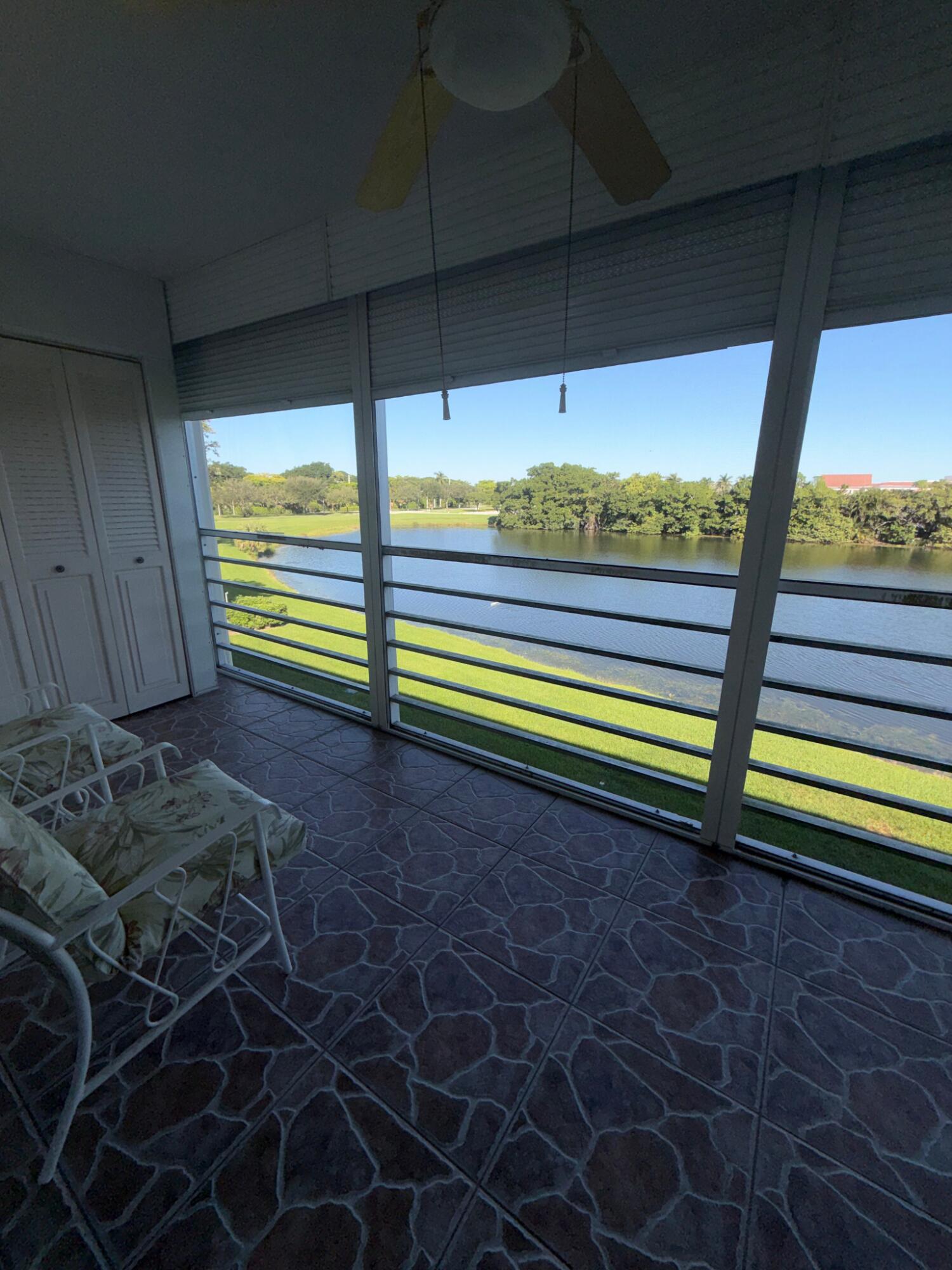 3058 Ainslie Drive, Unit 3058D Boca Raton, FL 33434 - Photo 7 of 13 a view of a two room with a bed and wooden floor
