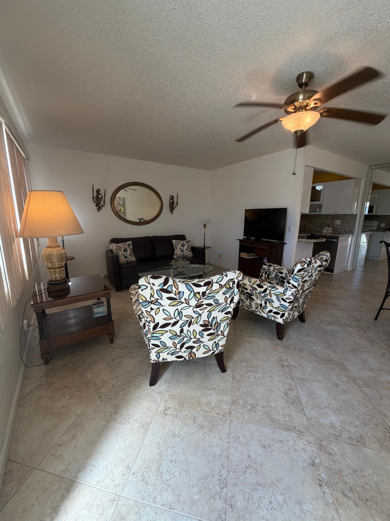 3058 Ainslie Drive, Unit 3058D Boca Raton, FL 33434 - Photo 10 of 13 a bedroom with furniture and a mirror