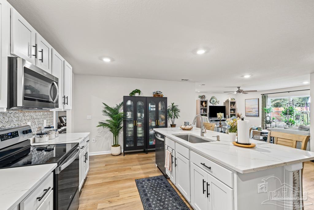 5277 Peach Drive Pace, FL 32571 - Photo 11 of 31 a kitchen with a sink stove and refrigerator