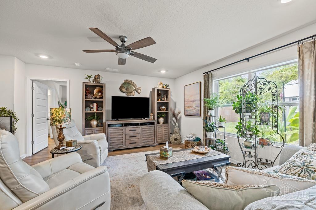 5277 Peach Drive Pace, FL 32571 - Photo 14 of 31 a living room with furniture and a flat screen tv