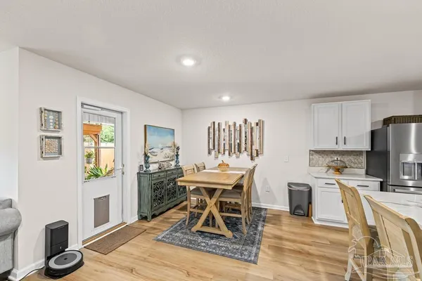 a work room with furniture a rug and white walls