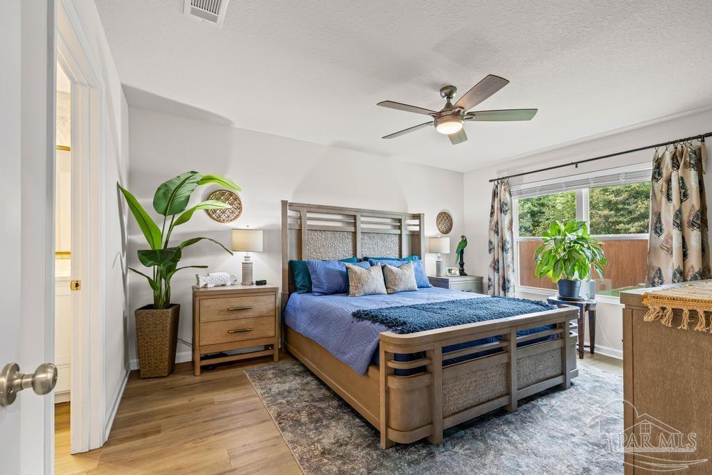 5277 Peach Drive Pace, FL 32571 - Photo 17 of 31 a bed sitting in a bedroom next to a window