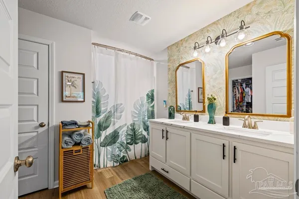 a bathroom with a double vanity sink and mirror