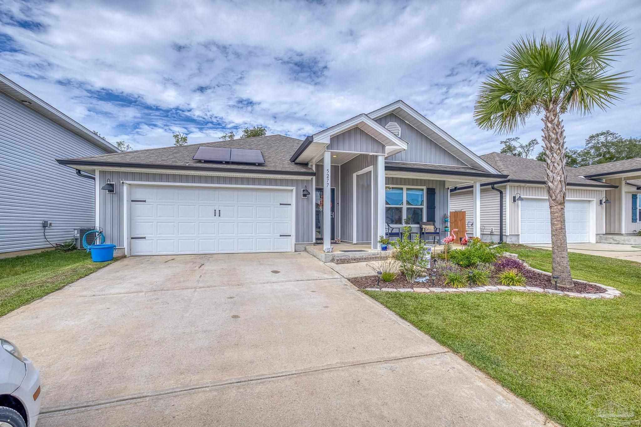 5277 Peach Drive Pace, FL 32571 - Photo 2 of 31 a front view of house with yard and green space
