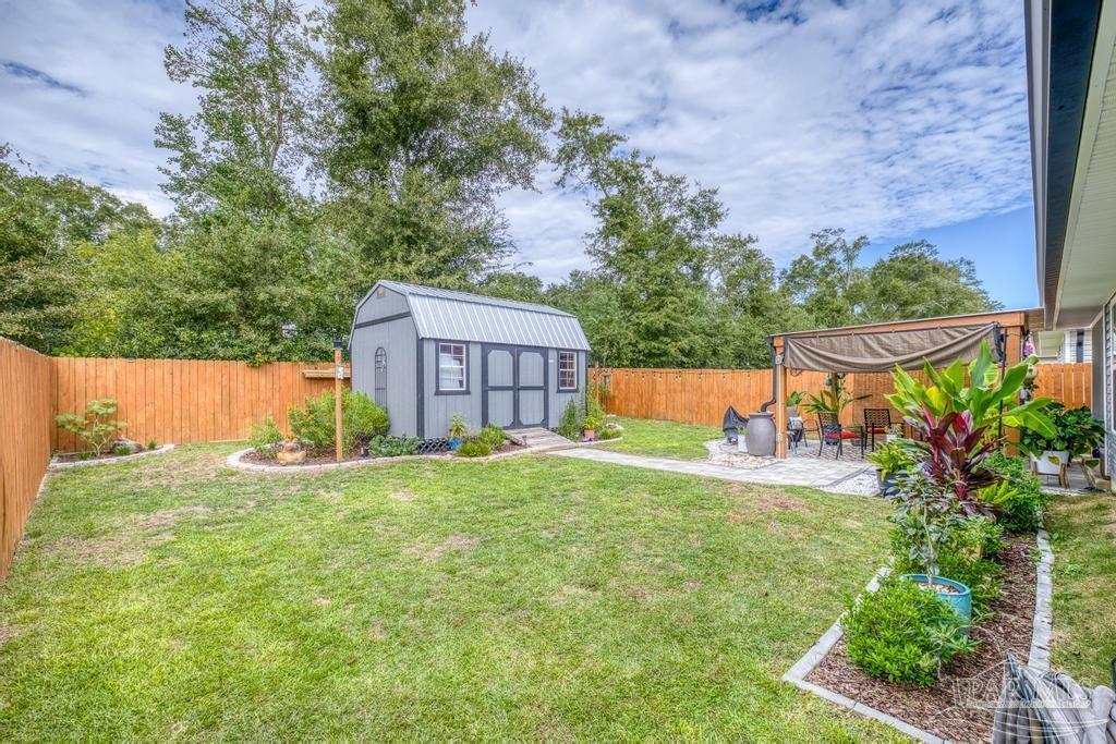5277 Peach Drive Pace, FL 32571 - Photo 26 of 31 front view of a house with a yard