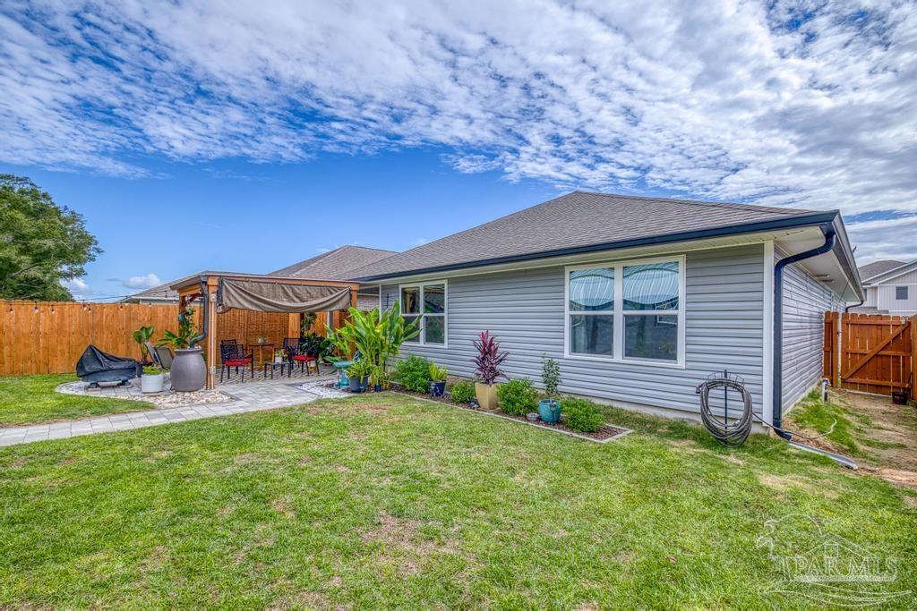 5277 Peach Drive Pace, FL 32571 - Photo 27 of 31 a backyard of a house with seating space