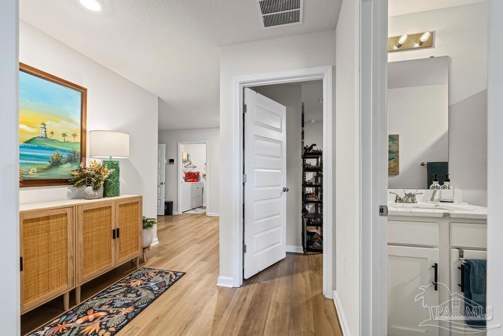 5277 Peach Drive Pace, FL 32571 - Photo 7 of 31 a kitchen with sink cabinets and wooden floor