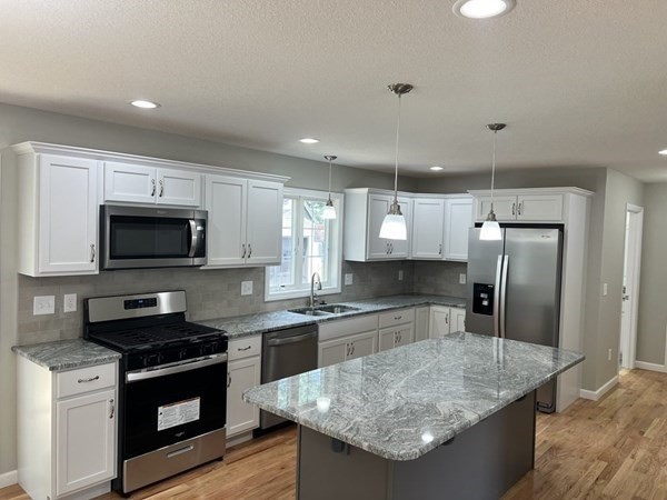 16 Ivan Springfield, MA 01104 - Photo 3 of 27 a kitchen with stainless steel appliances granite countertop a sink a stove and a refrigerator