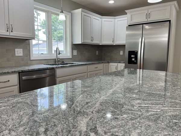 16 Ivan Springfield, MA 01104 - Photo 4 of 27 a kitchen with granite countertop a stove a sink and a refrigerator
