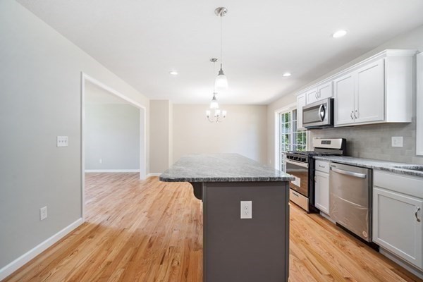 16 Ivan Springfield, MA 01104 - Photo 7 of 27 a kitchen with granite countertop stainless steel appliances and wooden cabinets