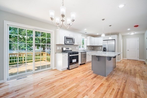 16 Ivan Springfield, MA 01104 - Photo 8 of 27 a large kitchen with kitchen island a large counter top and stainless steel appliances