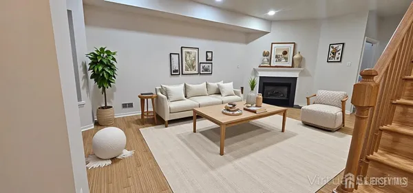 a living room with furniture a rug and a fireplace