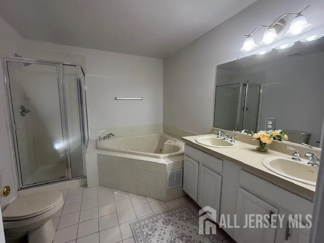 a bathroom with a tub sink toilet and mirror