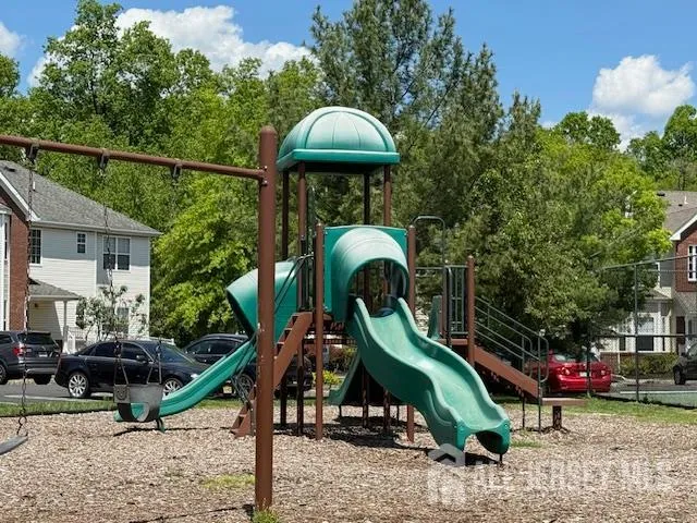 a childrens park with lots of swings and slides