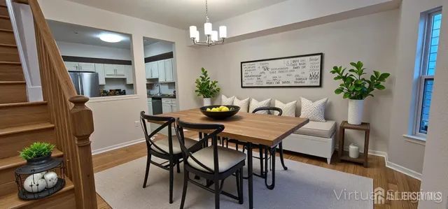 a view of a dining room with furniture and chandelier