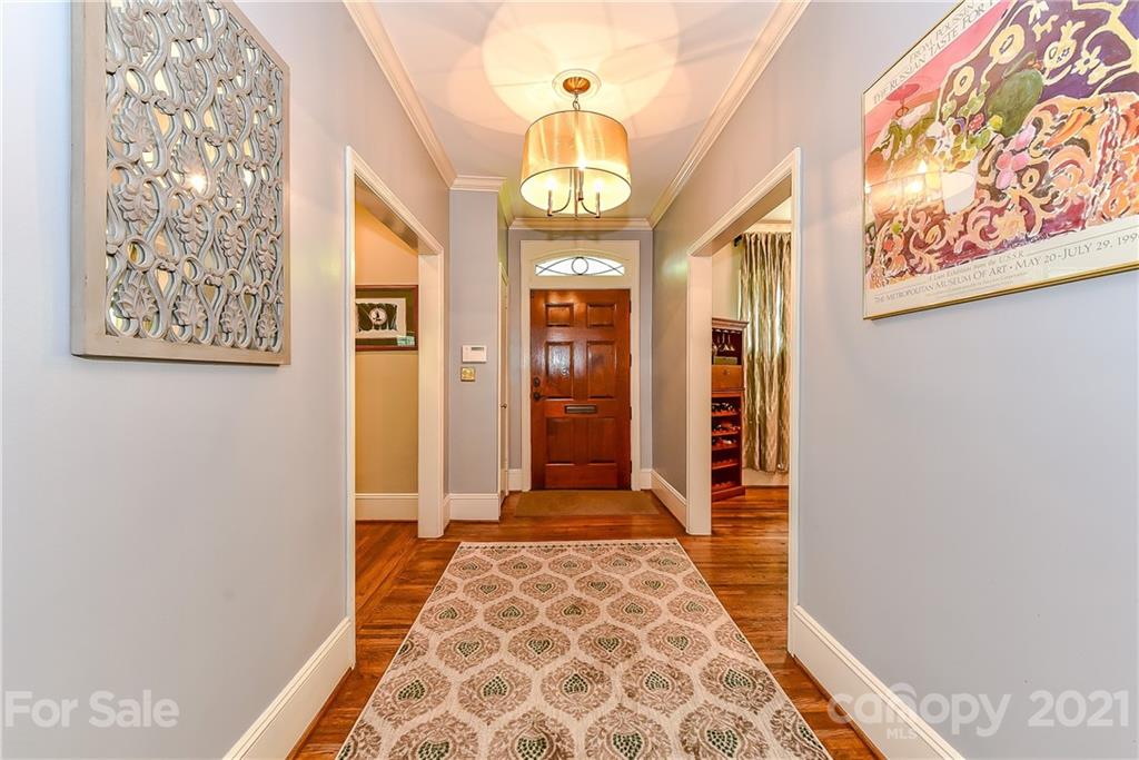 1405 Lilac Road Charlotte, NC 28209 - Photo 2 of 39 a hallway with beautiful frames and paintings on the wall