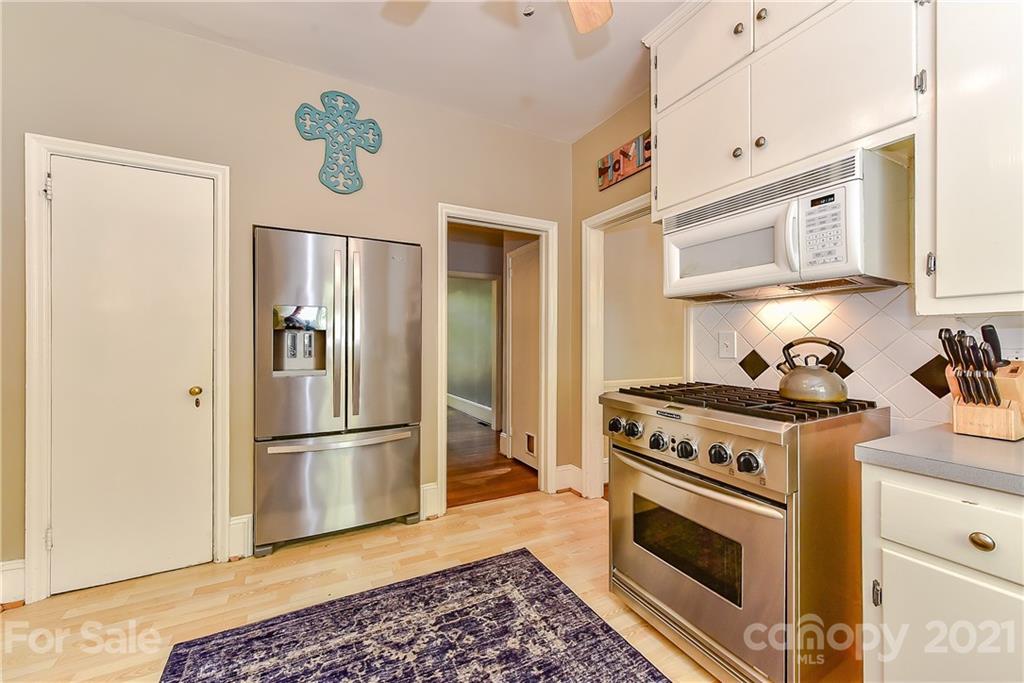1405 Lilac Road Charlotte, NC 28209 - Photo 13 of 39 a kitchen with stainless steel appliances granite countertop a refrigerator and a stove top oven