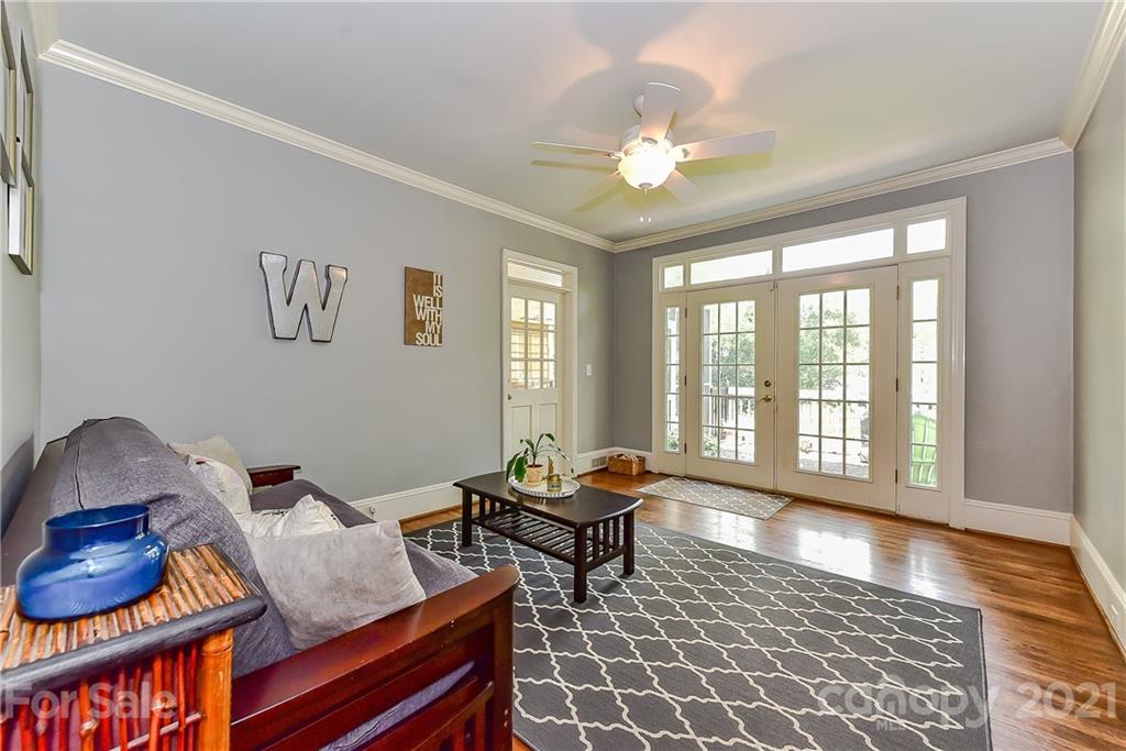 1405 Lilac Road Charlotte, NC 28209 - Photo 14 of 39 a living room with furniture and a floor to ceiling window