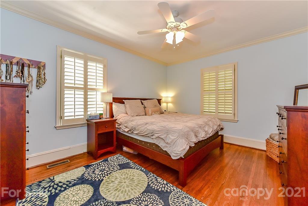 1405 Lilac Road Charlotte, NC 28209 - Photo 16 of 39 a bedroom with a bed and wooden floor
