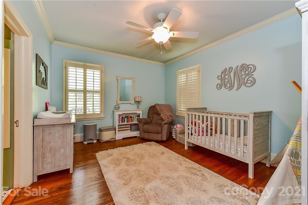 1405 Lilac Road Charlotte, NC 28209 - Photo 20 of 39 a living room with furniture and a baby crib