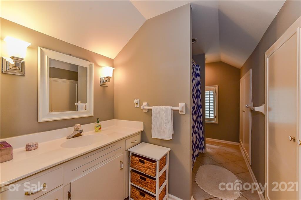 1405 Lilac Road Charlotte, NC 28209 - Photo 25 of 39 a bathroom with a sink and a mirror