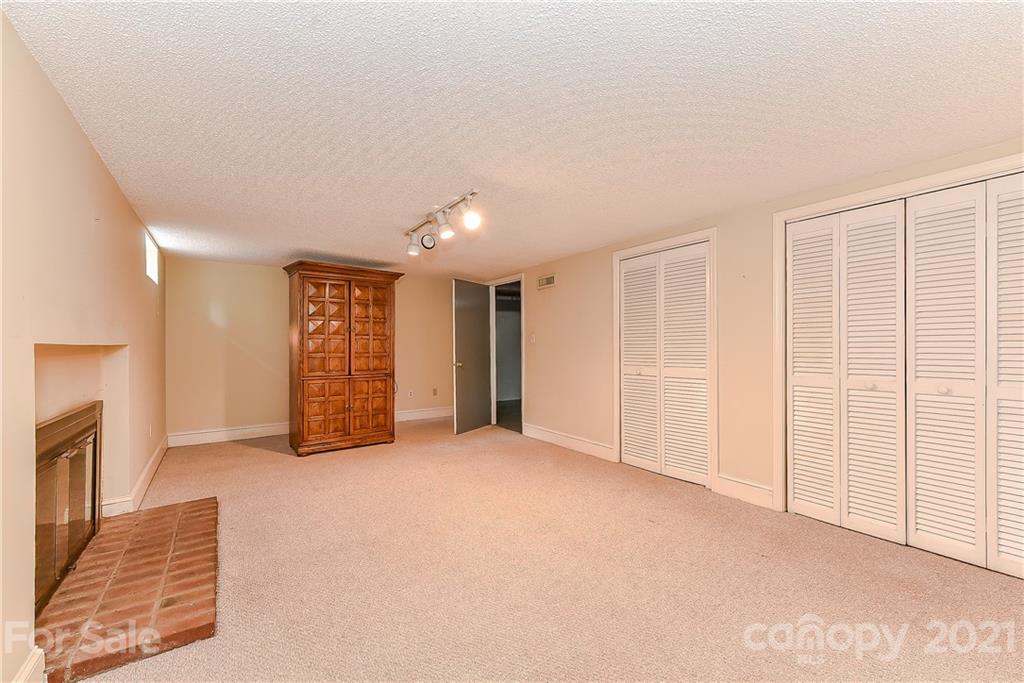 1405 Lilac Road Charlotte, NC 28209 - Photo 30 of 39 a view of an empty room with a fireplace