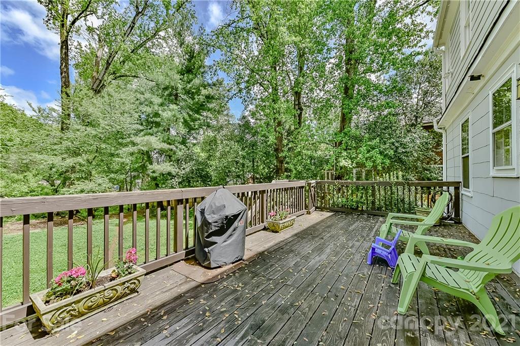 1405 Lilac Road Charlotte, NC 28209 - Photo 32 of 39 a view of a deck with two chair and wooden floor