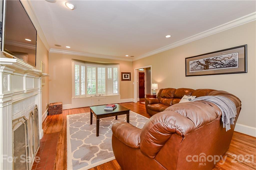 1405 Lilac Road Charlotte, NC 28209 - Photo 5 of 39 a living room with furniture a flat screen tv and a fireplace