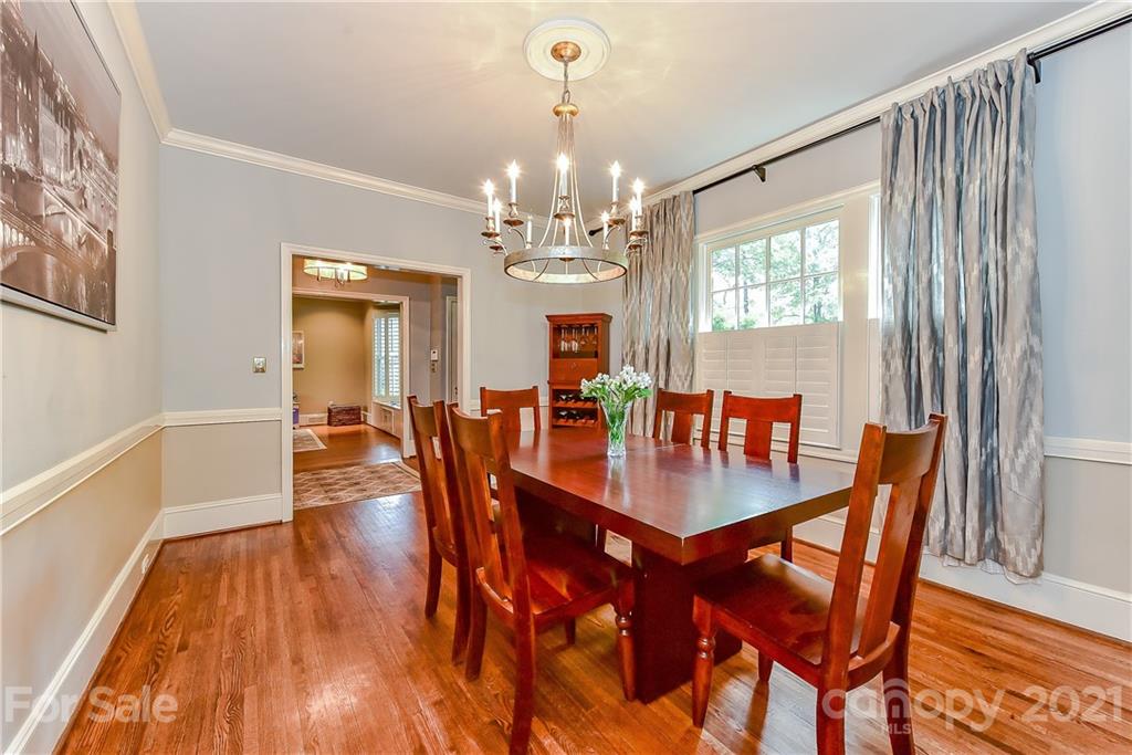 1405 Lilac Road Charlotte, NC 28209 - Photo 7 of 39 a view of a dining room with furniture a chandelier and wooden floor
