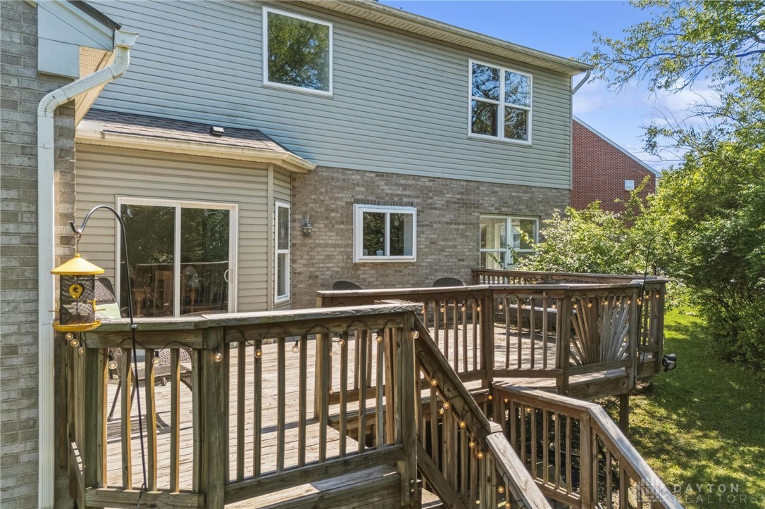 70 Martin Lane Springboro, OH 45066 - Photo 59 of 69 This spacious outdoor deck offers ample room for relaxation and entertaining, surrounded by lush greenery.