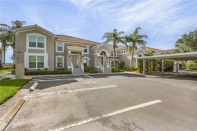 a front view of a house with a yard and outdoor seating
